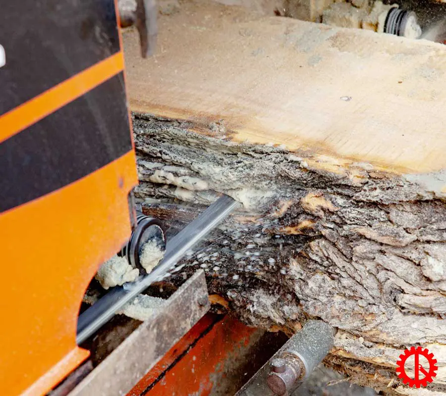 Close up of saw blade cutting wood of portable sawmill machine